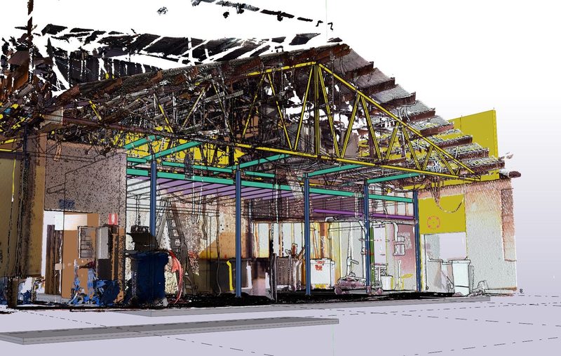 Point cloud of an existing building interior with roof trusses, overlaid with a Tekla model of new steel framing